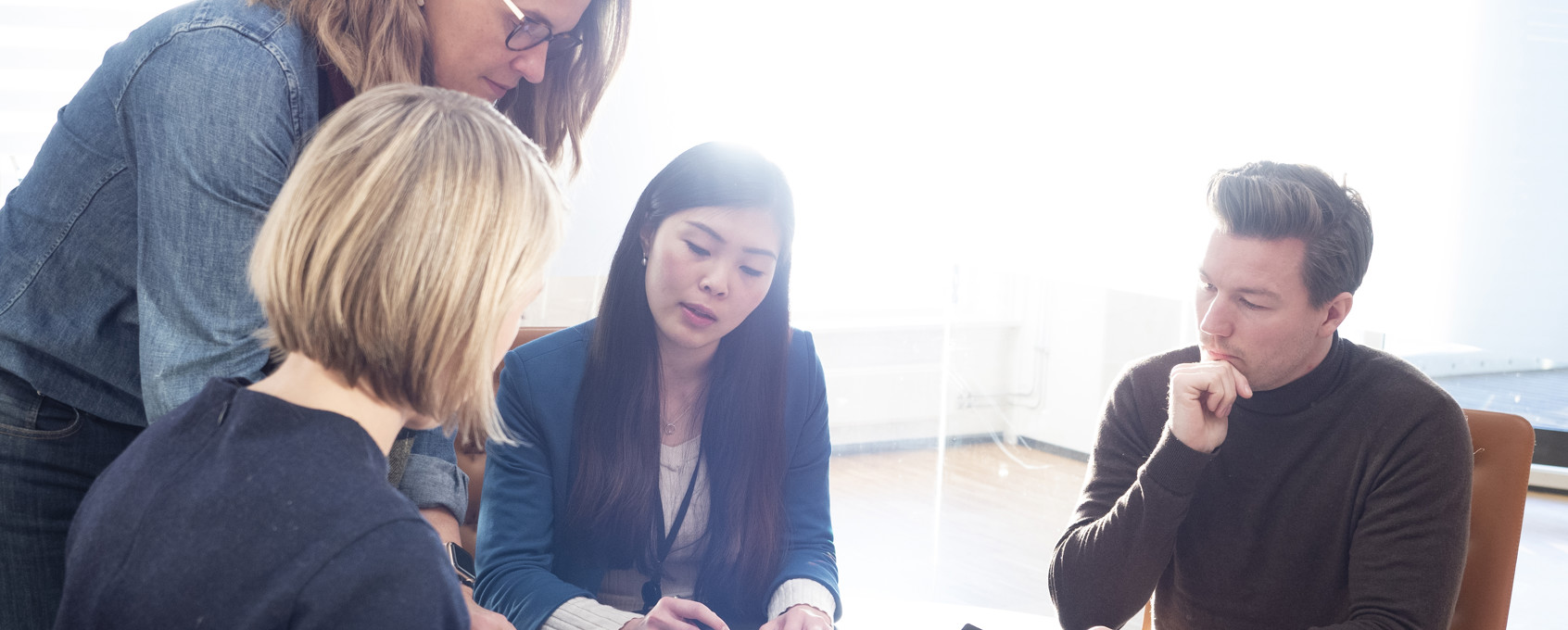 Office environment with people around a table