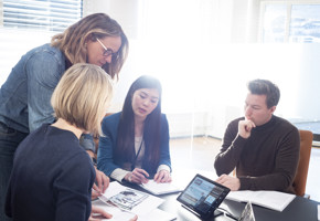 Office environment with people around a table