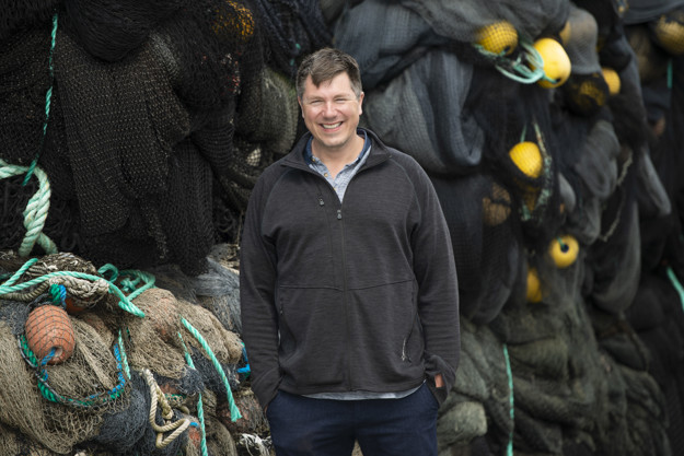 Man in front of old fishing gear